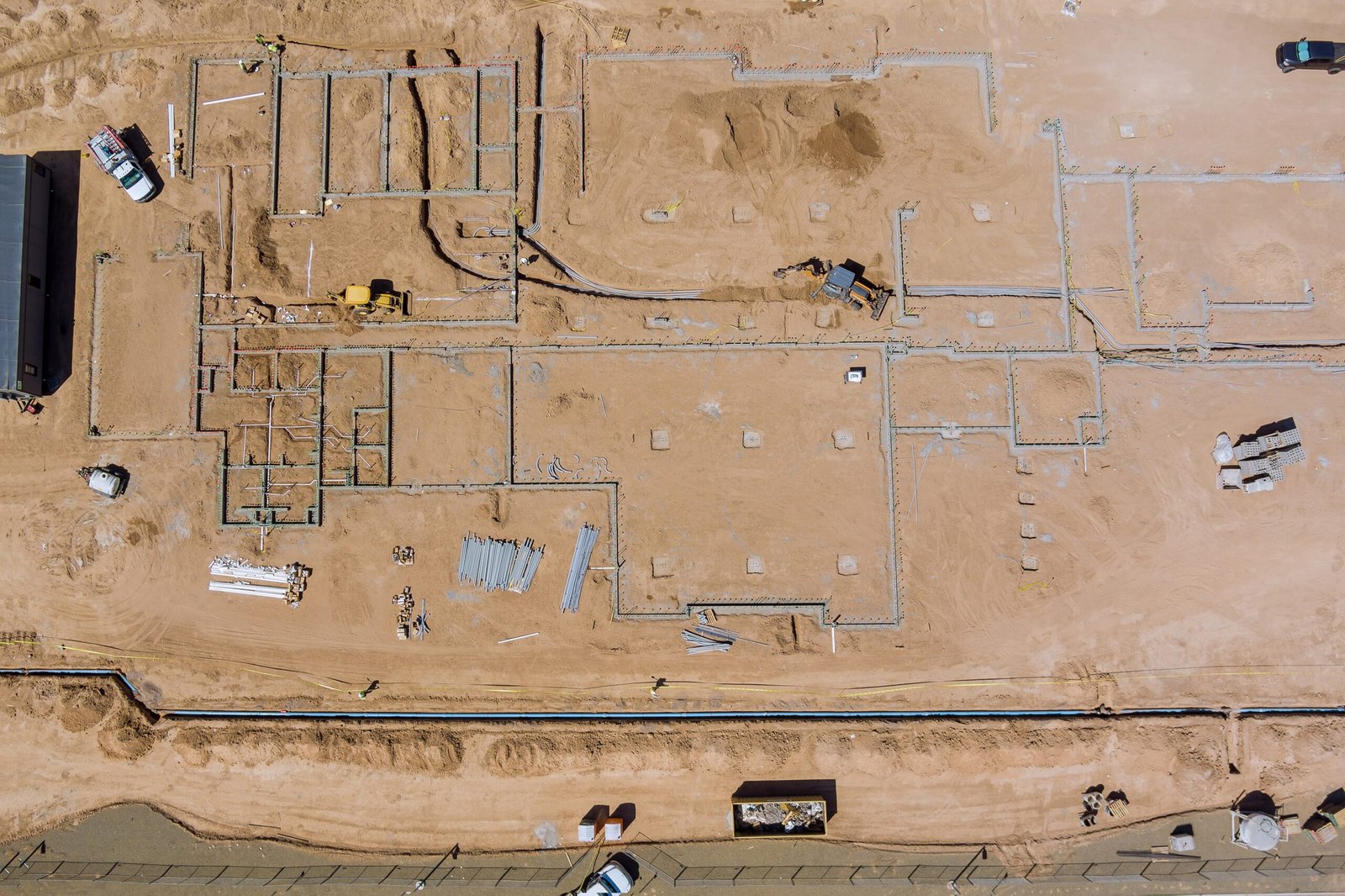Aerial view new residential complex buildings for construction work in the laying underground pipes in the foundation