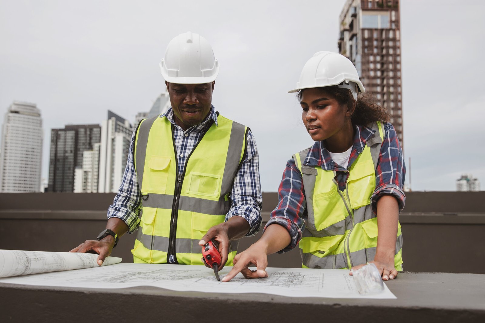 Team Engineers with draft plan of building on constructing site. Engineer work on site. engineer visit and inspection site engineer. Inspector engineer check and working on site.